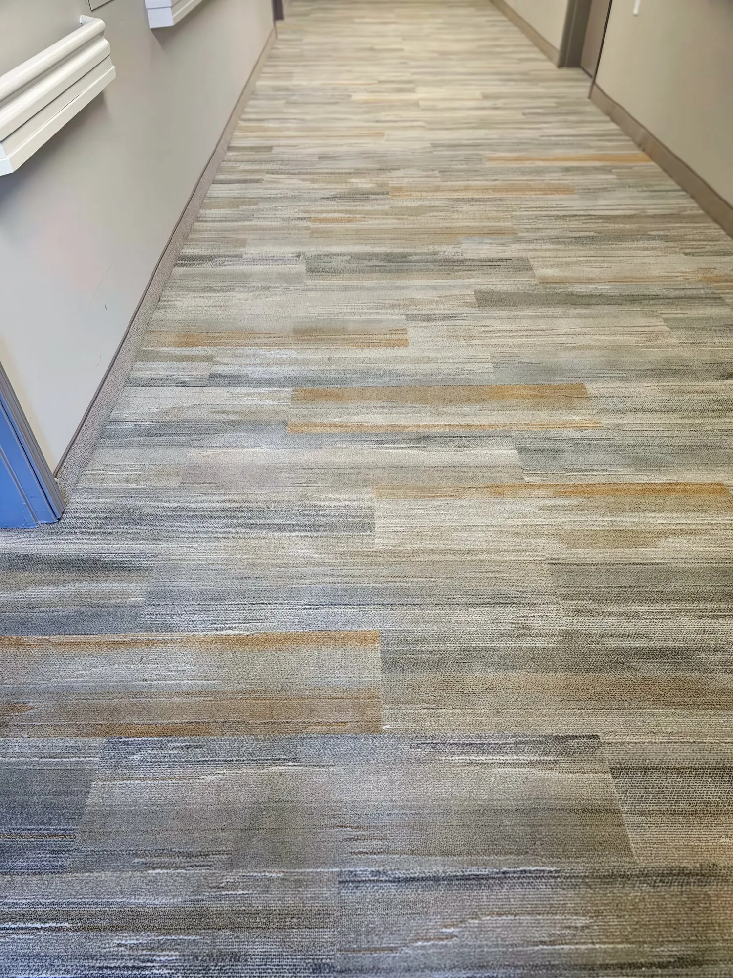 Clean striped commercial carpet in a hallway