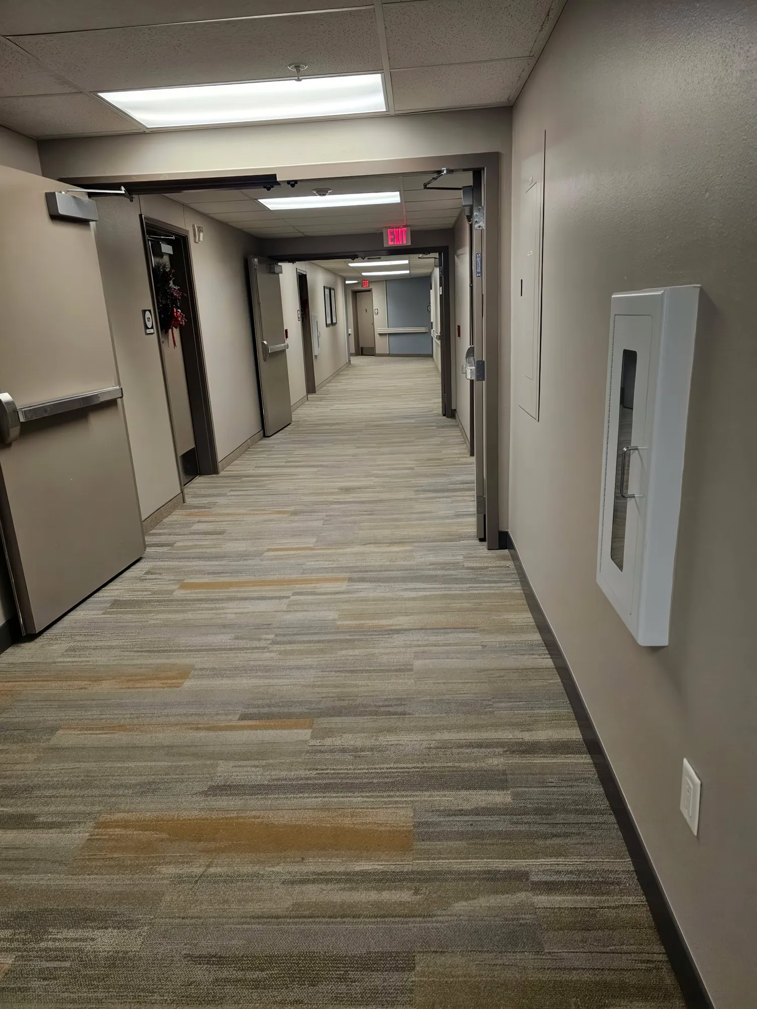 Long office hallway with clean patterned carpet