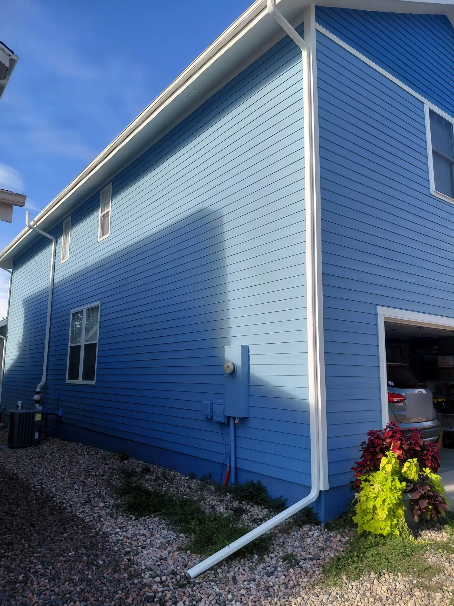 Two-story house with freshly painted blue siding and white trim