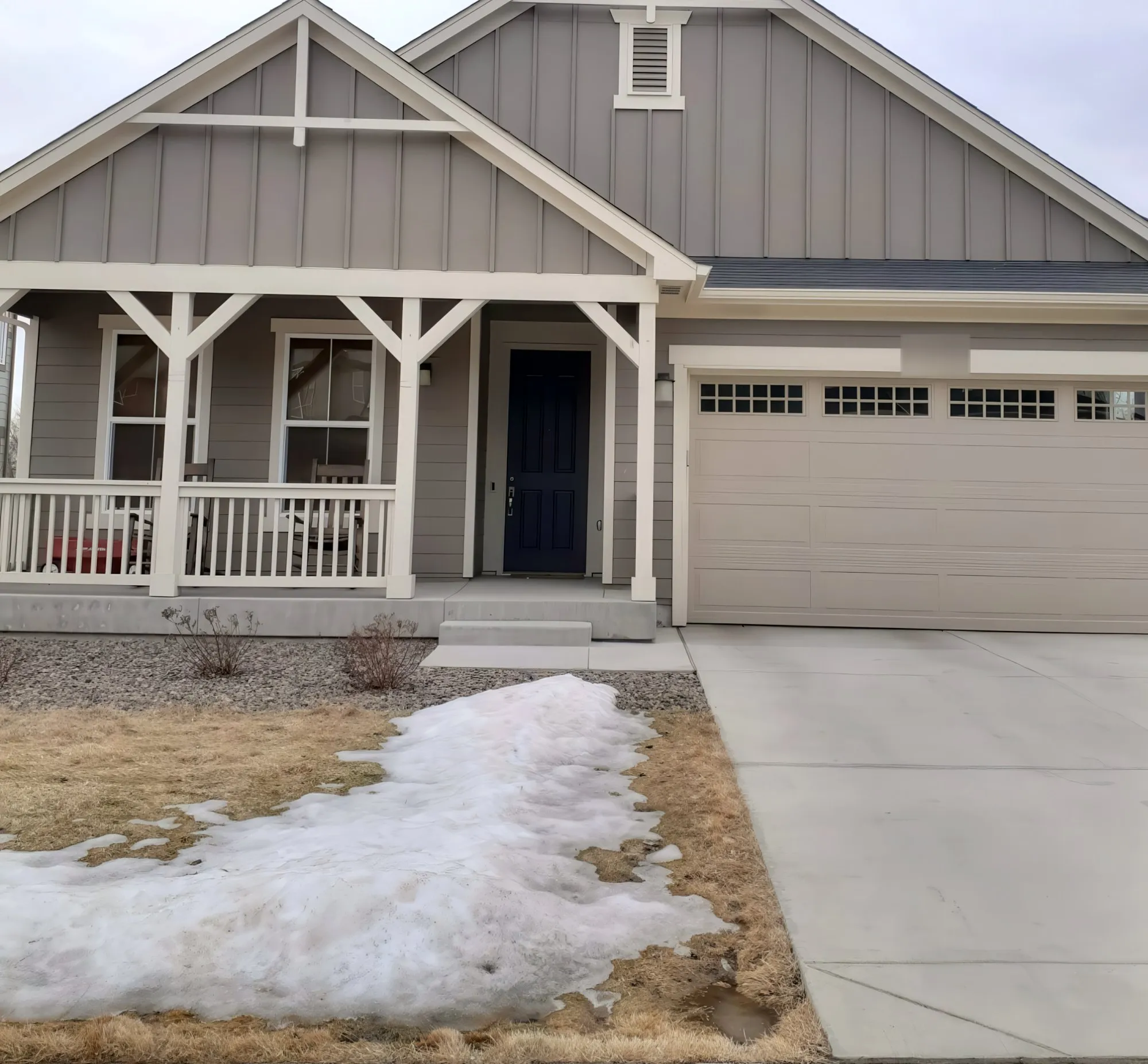 Gray single-story home with white trim and a covered porch