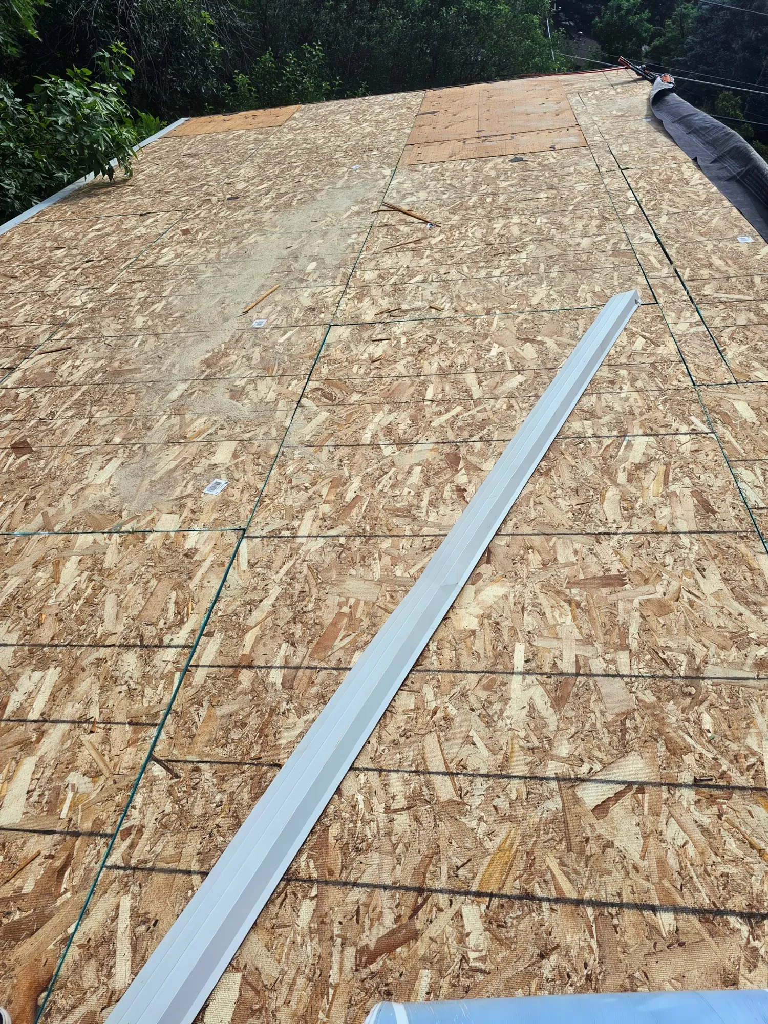 Roof stripped to wood decking with new drip edge ready to install